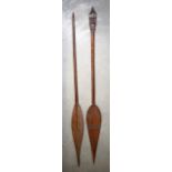 TWO LATE 19TH CENTURY TRIBAL CARVED WOOD PADDLES one with extensive geometric decoration. 163 cm lon