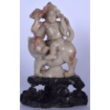 A 19TH CENTURY CHINESE CARVED SOAPSTONE STATUE OR BUDDHA, formed as a male figure riding on the back