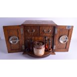 A LOVELY EDWARDIAN CARVED OAK SMOKERS DISPLAY CABINET the doors opening to reveal a fitted swivellin