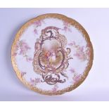 A LARGE FRENCH LIMOGES PORCELAIN DISH painted with lovers within a landscape. 34 cm wide.