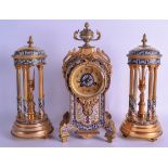 A 19TH CENTURY FRENCH BRONZE CHAMPLEVE ENAMEL CLOCK GARNITURE decorated with foliage and scrolling v