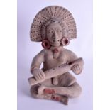 A 19TH CENTURY SOUTH AMERICAN PERUVIAN POTTERY FIGURE OF A MUSICIAN modelled playing a flute. 28 cm