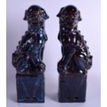A PAIR OF EARLY 20TH CENTURY CHINESE FLAMBE GLAZED BUDDHISTIC LIONS modelled upon square form plinth
