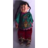 A REPUBLICAN PERIOD CHINESE WOODEN DOLL, dressed in silk clothing. 25 cm long.