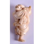 AN 18TH CENTURY JAPANESE EDO PERIOD CARVED IVORY NETSUKE modelled as a male with both arms raised. 6