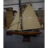 A LOVELY LARGE ANTIQUE WOODEN POND YACHT, formed with mixed wood inlay and associated stand. 142 cm