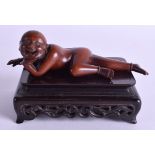 AN EARLY 20TH CENTURY CHINESE CARVED BOXWOOD FIGURE OF A RECLINING MALE modelled nude. 11 cm wide. (