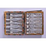 A CASED SET OF TWELVE CHINESE WHITE METAL FORKS AND SPOONS decorated with character marks. 144 grams
