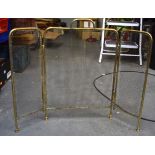 A BRASS FIRE GUARD, formed with a loop handle. 78 cm wide.