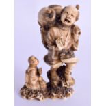 A 19TH CENTURY JAPANESE MEIJI PERIOD CARVED IVORY OKIMONO modelled as a male being attacked by an oc