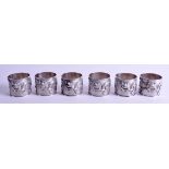 A SET OF SIX 19TH CENTURY CHINESE EXPORT SILVER NAPKIN RINGS decorated with dragons and calligraphy.