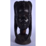 A LIGNUM VITAE AFRICAN WOODEN BUST, carved in the form of a female with braided hair. 28 cm high.