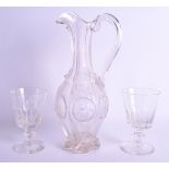AN ANTIQUE GLASS JUG together with a pair of 19th century monogrammed glasses. 33 cm & 15 cm high. (