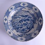 A 17TH CENTURY CHINESE SWATOW WARE PORCELAIN CHARGER painted with deer within landscapes. 38 cm wide