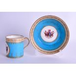 AN 18TH CENTURY SEVRES COFFEE CAN AND SAUCER painted with an Armorial with latin inscription. (2)