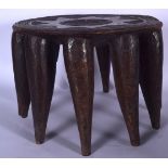 AN ANTIQUE AFRICAN SENUFO TRIBAL WOODEN STAND, formed with tapering legs and geometric carving. 24 c