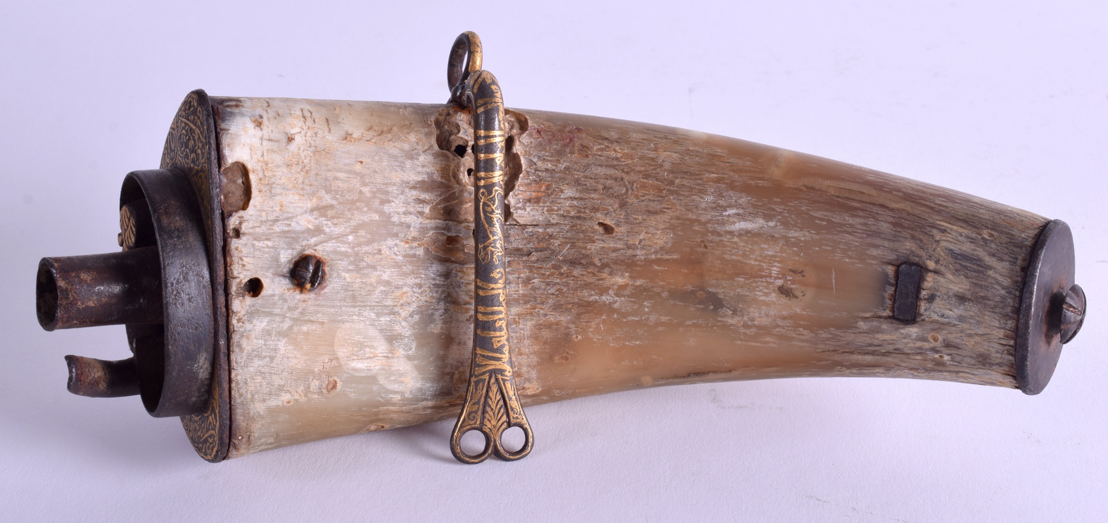 AN INDO PERSIAN GOLD INLAID STEEL POWDER FLASK decorated with script and foliage. 24 cm long.