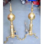 A PAIR OF EARLY 20TH CENTURY BRASS ANDIRONS, formed with bulbous body on curved legs. 57 cm high.