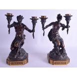 A GOOD PAIR OF 19TH CENTURY FRENCH BRONZE CANDLESTICKS modelled as figures upon naturalistic bases.