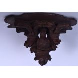 AN EARLY 20TH CENTURY GERMAN CARVED BLACK FOREST WALL BRACKET, in the form of a nesting bird. 22.5 c