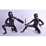 A PAIR OF EARLY 20TH CENTURY SOUTH EAST ASIAN BRONZE FIGURES OF WARRIORS modelled holding fighting s