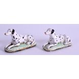 A PAIR OF 19TH CENTURY STAFFORDSHIRE FIGURE OF DALMATIONS modelled recumbent 6 cm wide.