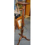 A WOODEN TORCHERE STAND. 130 cm.