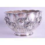 A 19TH CENTURY JAPANESE MEIJI PERIOD EMBOSSED SILVER BOWL decorated in relief with extensive foliage