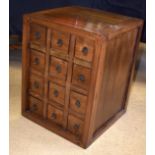 AN EARLY 20TH CENTURY CHINESE CARVED HARDWOOD SPICE CHEST with removable drawers. 59 cm x 46 cm x 45