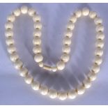 A LARGE IMITATION IVORY MARBLED BEAD NECKLACE, of spherical form. Total length 72 cm.