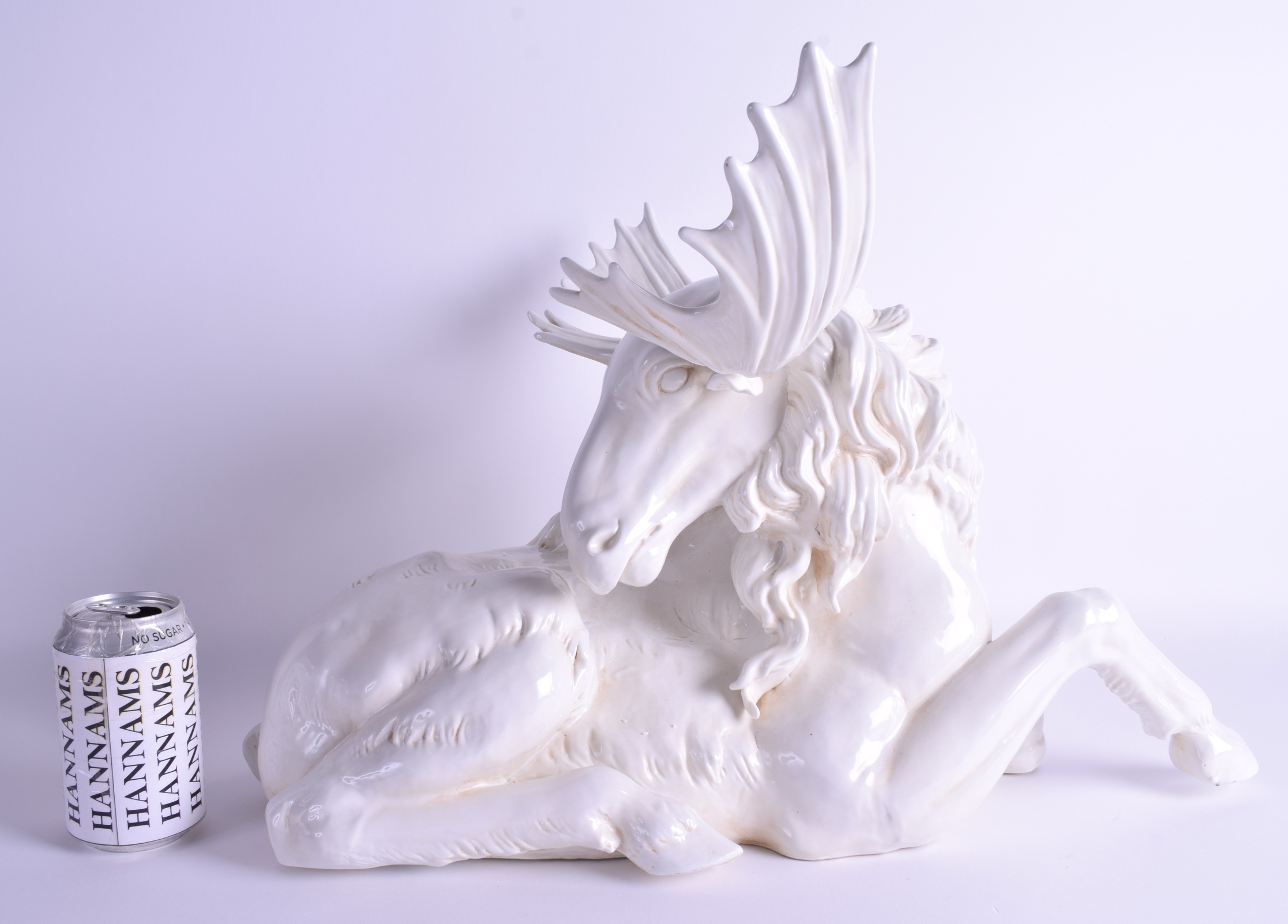 A LARGE CONTINENTAL PORCELAIN GROUP OF A RECUMBANT MOOSE modelled with its head turned. 52 cm x 37 c