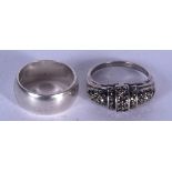 A SOLID SILVER RING, together with another similar. (2)