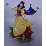 A LARGE FRANKLIN MINT PORCELAIN FIGURINE OF DISNEY SNOW WHITE, formed standing beside a rabbit holdi