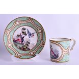 AN 18TH/19TH CENTURY SEVRES PORCELAIN CUP AND SAUCER painted with two birds within landscapes. (2)