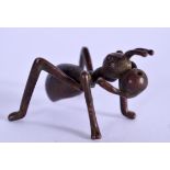 A JAPANESE TAISHO PERIOD BRONZE OKIMONO IN THE FORM OF AN ANT, formed carrying food. 5.5 cm long.
