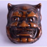 A LOVELY 18TH/19TH CENTURY JAPANESE EDO PERIOD BOXWOOD NETSUKE in the form of an oni mask head. 4 cm