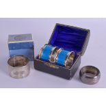 A CASED PAIR OF ART DECO SILVER AND ENAMEL NAPKIN RINGS together with two others. (4)