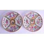 A PAIR OF 19TH CENTURY CHINESE CANTON FAMILLE ROSE PLATES painted with figures and birds. 26 cm diam
