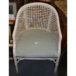 A WHITE WICKER CHAIR.