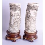 A GOOD PAIR OF 19TH CENTURY JAPANESE MEIJI PERIOD CARVED IVORY TUSK VASES decorated with figures wit