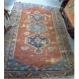 AN ANTIQUE CAUCASIAN RUG, decorated with foliage and motifs. 203 cm x 133 cm.