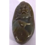 A CHINESE HARDSTONE GREEN JADE BOULDER, carved in relief with a scowling bearded immortal. 9 cm x 4.