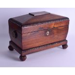 A LARGE EARLY VICTORIAN CARVED ROSEWOOD TWIN DIVISION TEA CADDY with reeded decoration and bun feet.