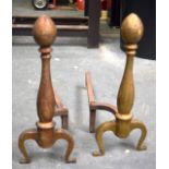 A PAIR OF EARLY 20TH CENTURY BRASS ANDIRONS, formed on curving legs. 43 cm high.