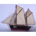 AN ANTIQUE WOODEN POND YACHT, formed with original rigging , painted black and red. 46 cm x 57 cm.