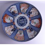 A VERY LARGE 19TH CENTURY JAPANESE MEIJI PERIOD IMARI CHARGER painted with dragons, figures and land