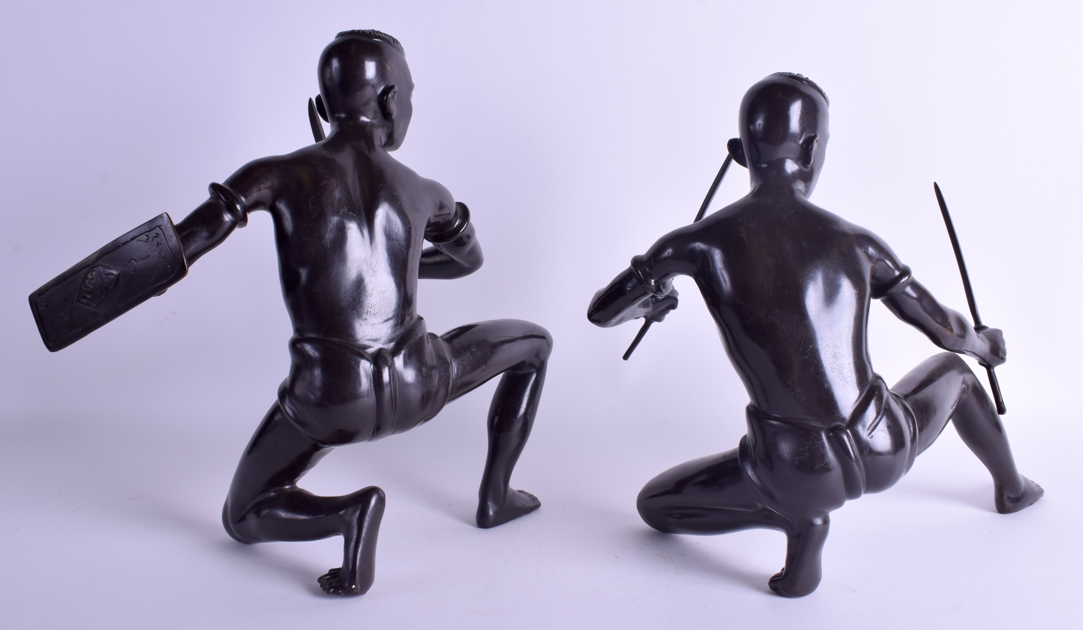 A PAIR OF EARLY 20TH CENTURY SOUTH EAST ASIAN BRONZE FIGURES OF WARRIORS modelled holding fighting s - Image 2 of 3
