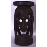 AN UNUSUAL LARGE AFRICAN TRIBAL FIGURE STOOL, inset with startled white eyes and dagger like teeth,