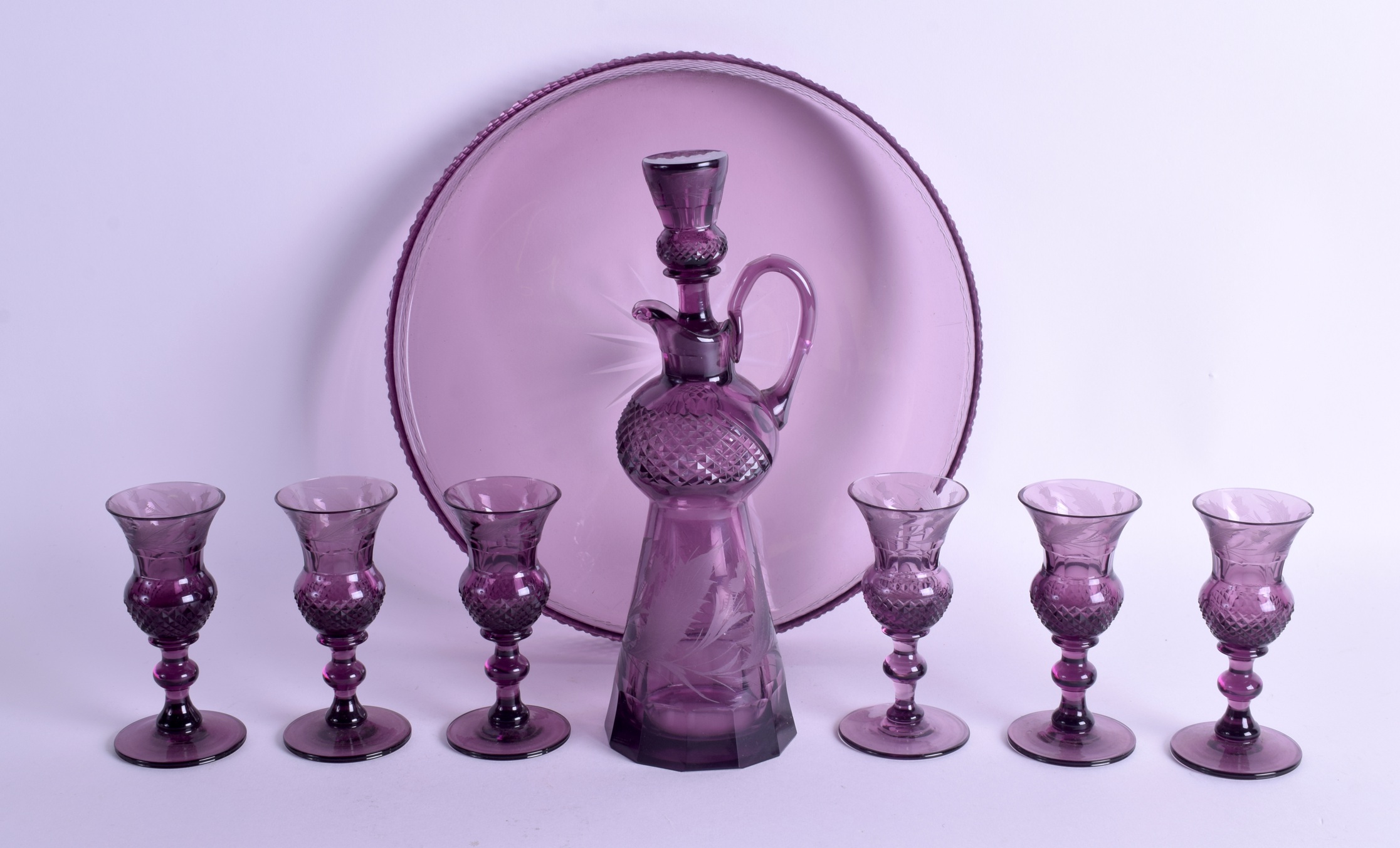 AN UNUSUAL VICTORIAN SCOTTISH AMETHYST GLASS LIQUIOR SET comprising of decanter, six glasses & tray