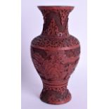 A 19TH CENTURY CHINESE CARVED CINNABAR LACQUER VASE Qing, decorated with figures within landscapes.